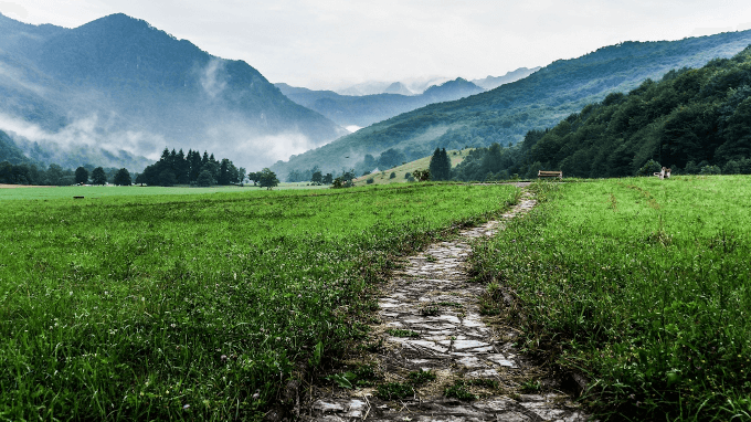 Grassy pathway between the mountains